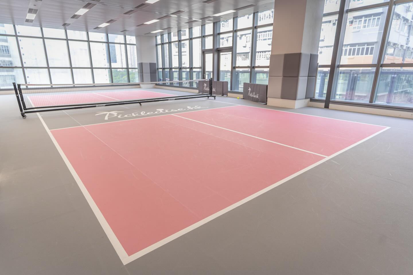 Pink show court with branded sideline barriers