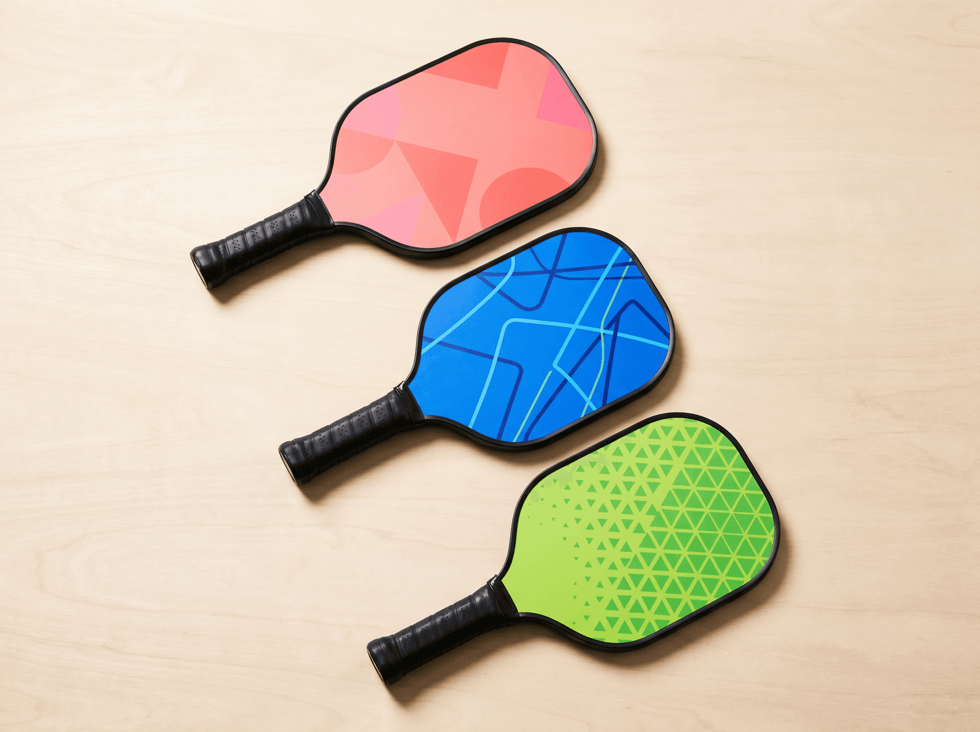 Junior pickleball paddles in saturated colors arranged flat
