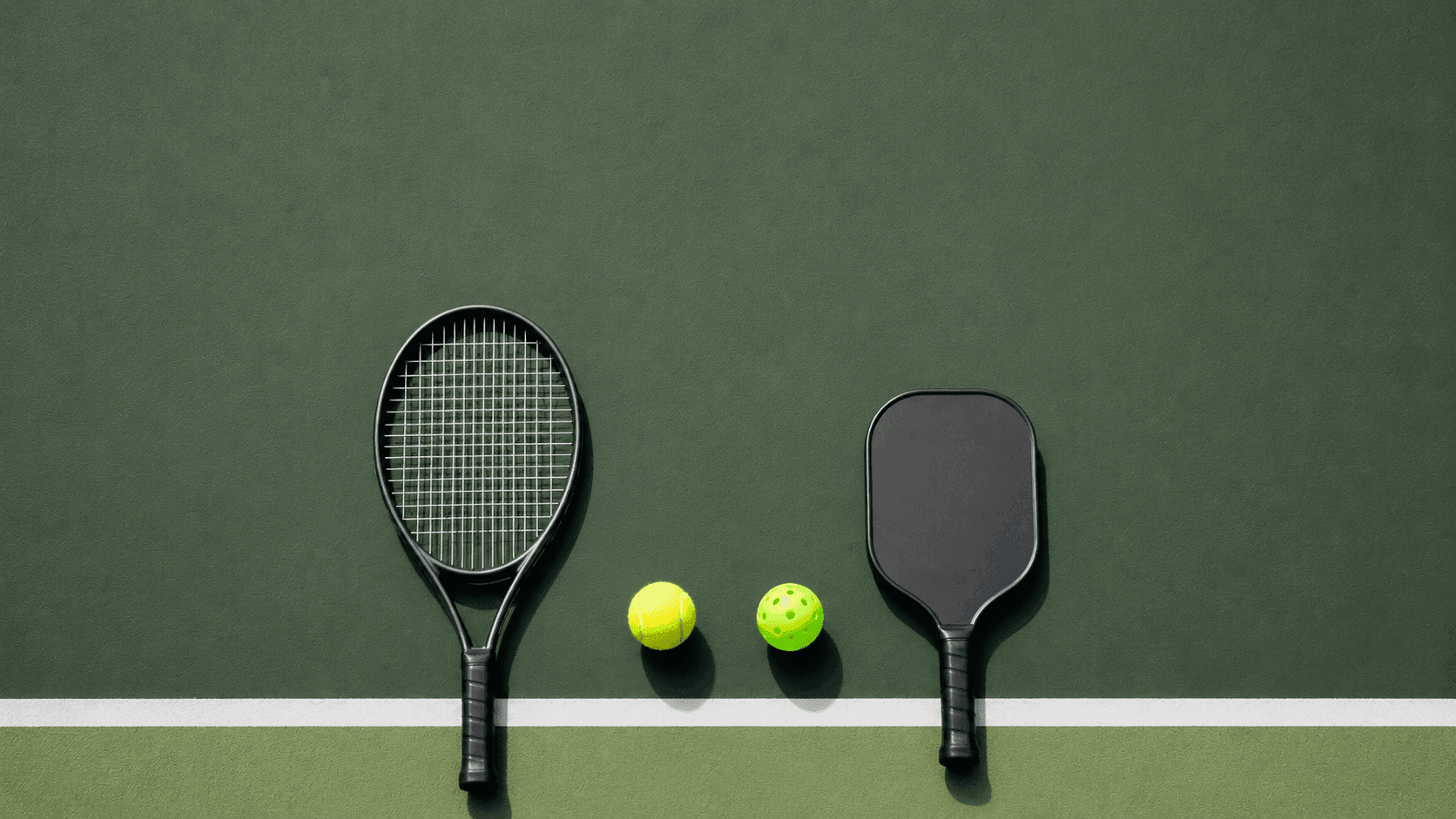 Top-down museum plate of a tennis racquet and a pickleball paddle side by side on forest green felt, tennis ball and pickleball between them.